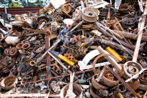 A pile of mixed scrap metal and construction debris including rusty iron and steel parts